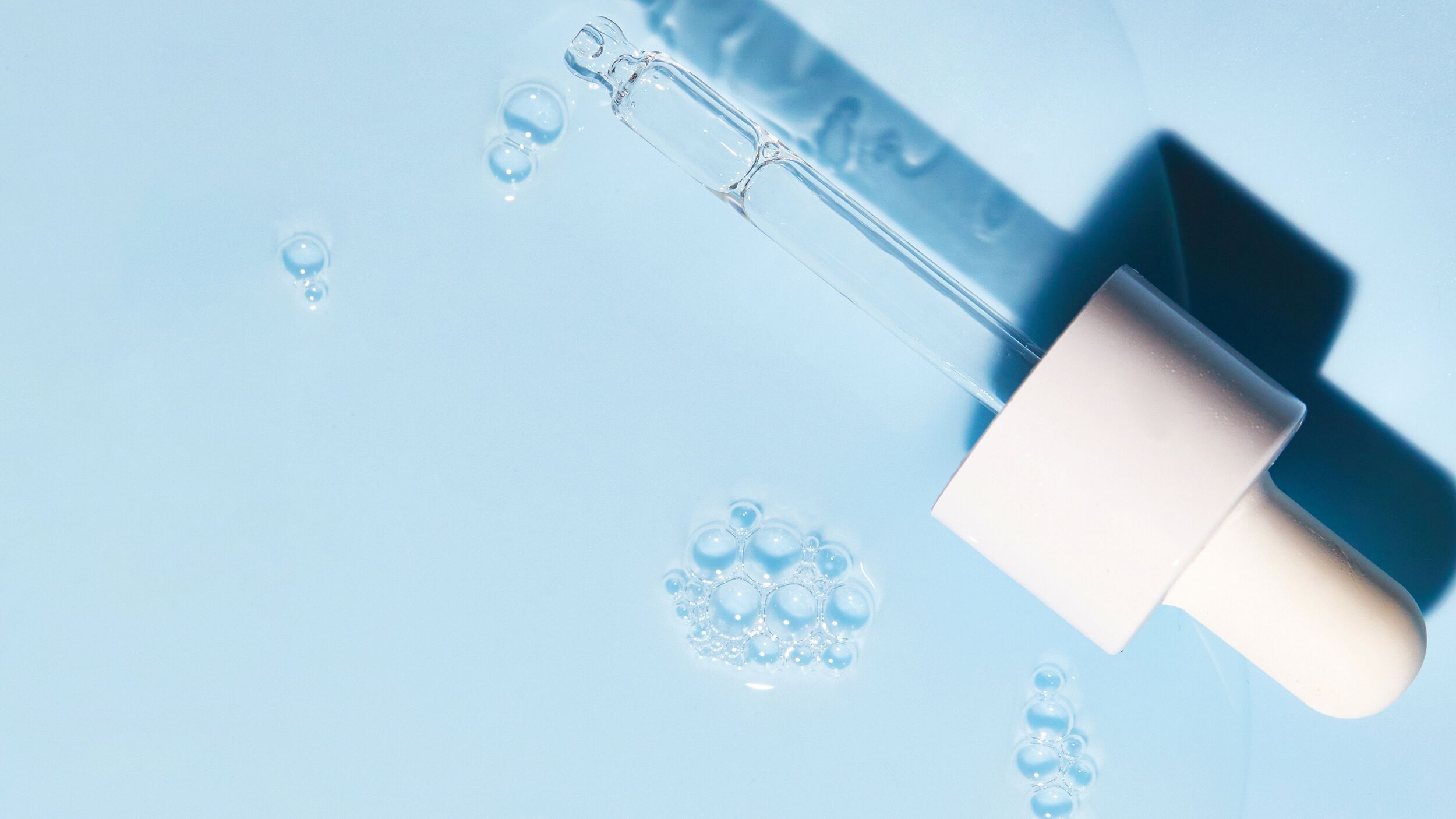 superdrops-image.jpg Serum pipette with a blue background